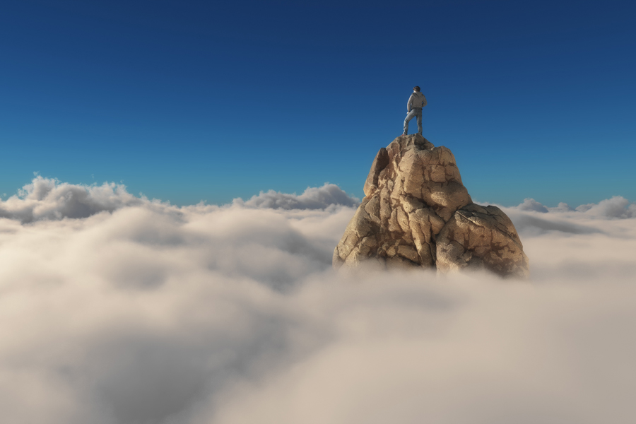 L’Active Recovery pour éviter l'épuisement professionnel: un homme se tient sur un pic de montagne au-dessus des nuages