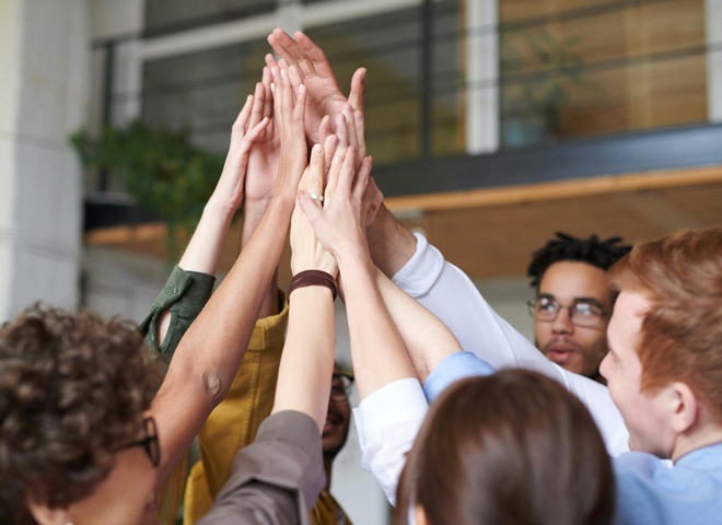 People Operations Manager, une approche nouvelle: une équipe de collègues se congratulent avec un "high five"
