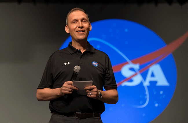 Astrophysiker der NASA und ETH Professor Thomas Zurbuchen hält ein Keynote über Leadership. Im Hintergrund steht das NASA Logo.