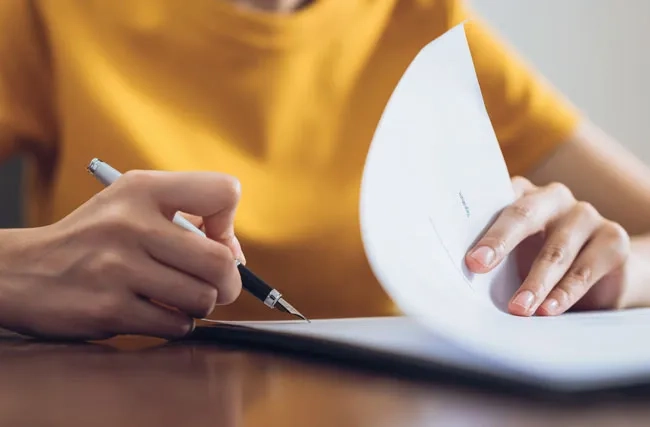 Frau unterschreibt einen Vertrag
