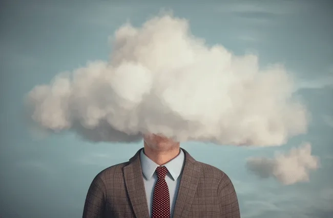 Ein Geschäftsmann mit dem Kopf in den Wolken, symbolisch für die Illusion der Stabilität in einer sich rasch verändernden Welt