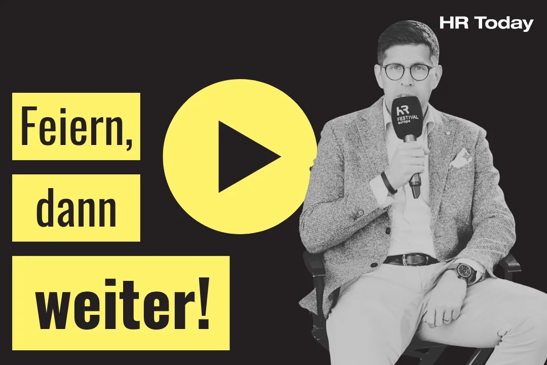 „Feiern, dann weiter!“ auf gelbem Hintergrund. In der Mitte befindet sich ein gelbes Play-Symbol. Rechts sitzt ein Mann im Sakko mit Brille, der ein Mikrofon mit der Aufschrift „HR FESTIVAL europe“ in der Hand hält.